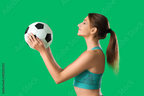 Young woman holding a socce...