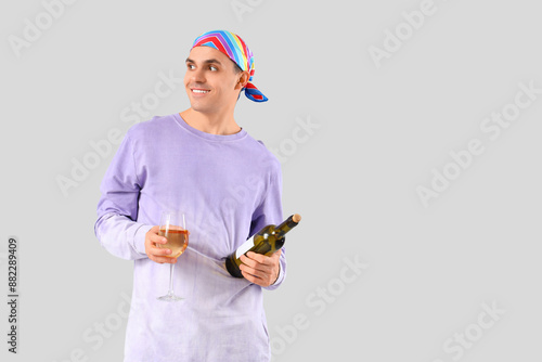 Young man with bottle and g...