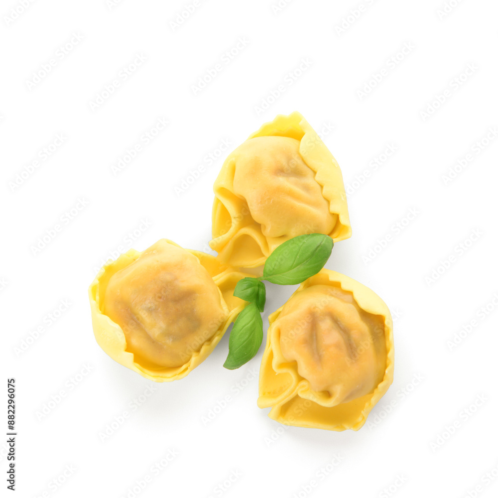 Raw dumplings with basil on white background Raw dumplings with basil on white background