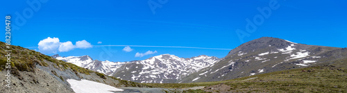 Panoramic view on snowy mountains on hiking trail to Mulhacen peak in the spring, Sierra Nevada range, Andalusia, Spain