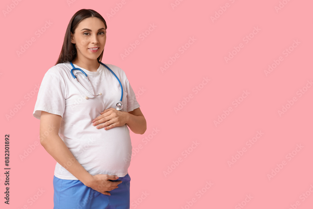 Beautiful young pregnant doctor on pink background Beautiful young pregnant doctor on pink background
