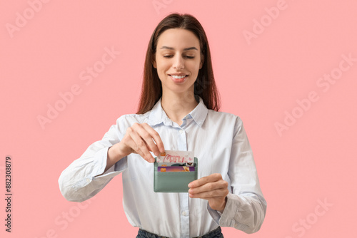 Young woman holding wallet ...