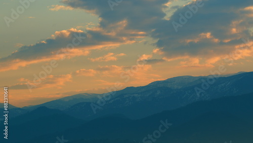 Mountain Top With Sunset. Clouds Float. Blue And Orange Clouds Flow In Sky. Pan.