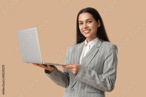 Happy businesswoman with la...