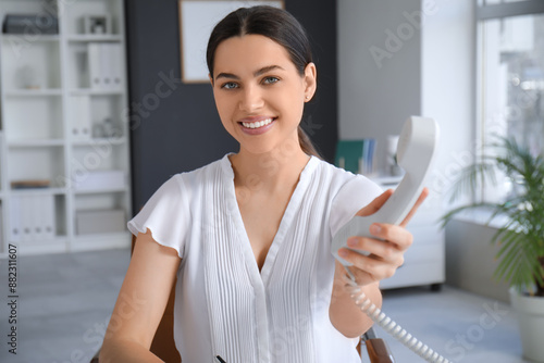 Pretty businesswoman giving...