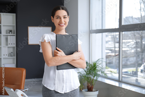 Pretty businesswoman with c...