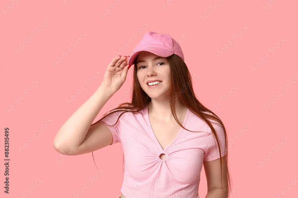 Stylish young girl in baseball cap on pink background Stylish young girl in baseball cap on pink background