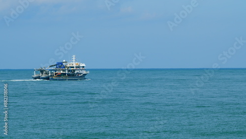 Fishing Ship In The Calm Sea. Fishing Boat Out In The Ocean Or Sea Wide. Still. photo