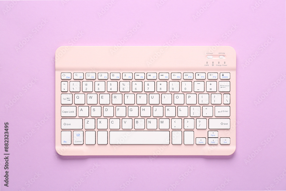Pink computer keyboard on lilac background. Top view Pink computer keyboard on lilac background. Top view
