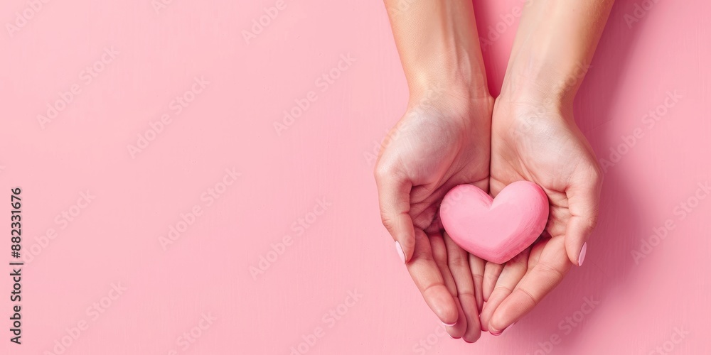 Woman's hands holding pink heart on a light pink background, Valentine's Day background Woman's hands holding pink heart on a light pink background, Valentine's Day background