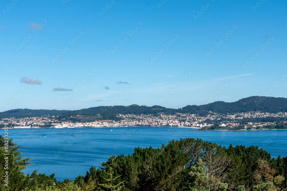 Panoramic view of the fishing village of Cangas in the Vigo estuary from the O Castro mountain. Galicia, Spain. Panoramic view of the fishing village of Cangas in the Vigo estuary from the O Castro mountain. Galicia, Spain.