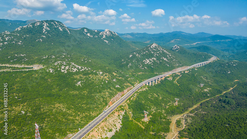 An impressive aerial view capturing the toll booth(Naplatna postaja) on the A6 Rijeka - Zagreb Motorway and the stunning peak of Kamenjak vrh. The motorway, known for its engineering marvels photo