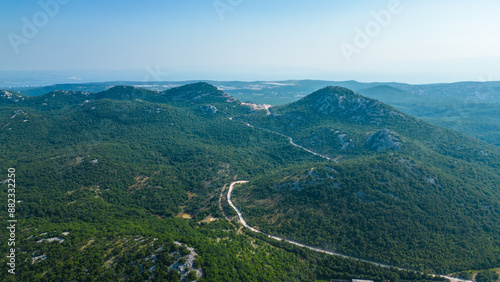 An impressive aerial view capturing the toll booth(Naplatna postaja) on the A6 Rijeka - Zagreb Motorway and the stunning peak of Kamenjak vrh. The motorway, known for its engineering marvels photo