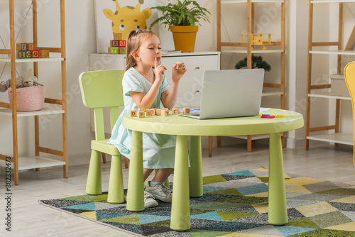 Little girl having online l...