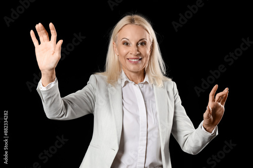Mature businesswoman using ...