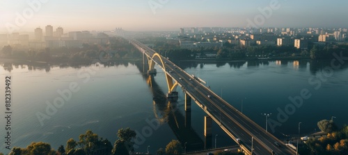 Aerial View of Modern Bridge Spanning River with Cityscape and Urban Integration photo