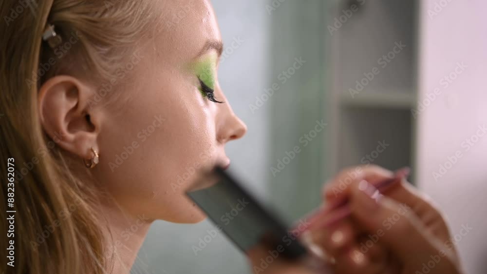 master combs the eyelashes of the client after the eyelash extension procedure. Cosmetology. woman with eyelash extension. master combs the eyelashes of the client after the eyelash extension procedure. Cosmetology. woman with eyelash extension.