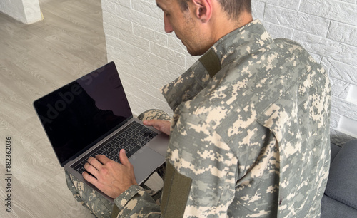 Soldier with laptop on white background