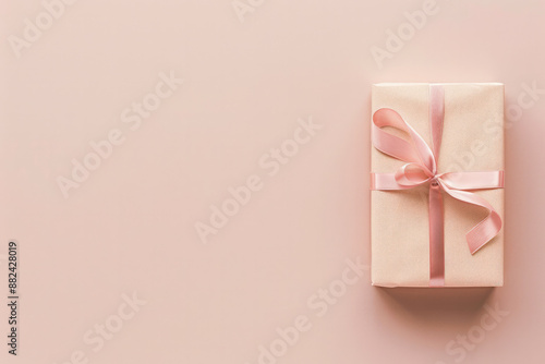 A minimalist image featuring gift box on the right. The gift is wrapped in pastel paper with a ribbon bow, against a solid, neutral background with empty space on the left