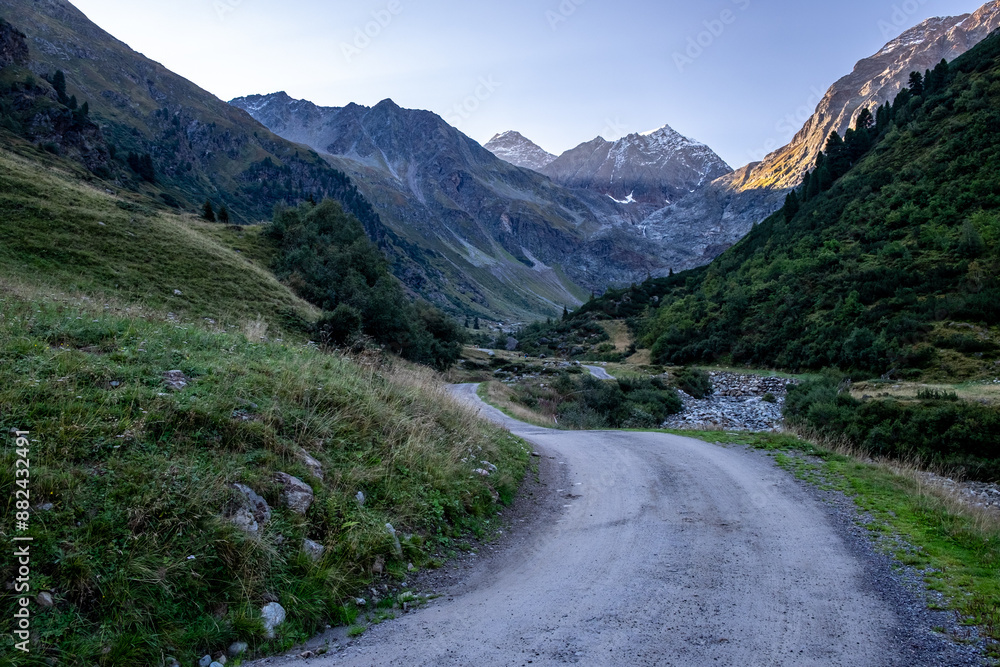 Naklejka premium Mountain Valley with Winding Road
