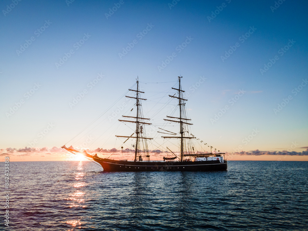 Tall Ship at Sunset on Calm Waters Tall Ship at Sunset on Calm Waters