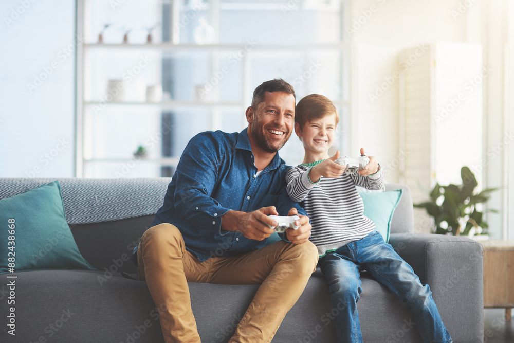 Happy father, child and playing with controller for video games, entertainment or bonding on sofa at home. Dad, son or kid with smile and enjoying esports, competition or fun on console at house Happy father, child and playing with controller for video games, entertainment or bonding on sofa at home. Dad, son or kid with smile and enjoying esports, competition or fun on console at house