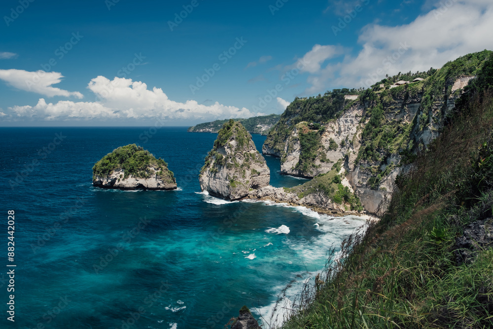 A landscape of the coastline made of cliffs and turquoise water A landscape of the coastline made of cliffs and turquoise water