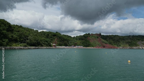 Oddicombe, South Devon, England: DRONE VIEWS: Low angle view of Oddicombe beach and the Babbacombe Cliff Railway. Babbacombe is a popular English holiday resort with beautiful coastline views (Clip 1) photo