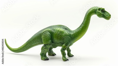 Fototapeta Naklejka Na Ścianę i Meble -  A realistic-looking green dinosaur toy with a long neck and tail, characteristic of a Brachiosaurus, standing on a plain white background with detailed texturing.