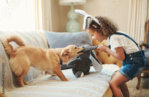 Photography Girl child, dog and play with toy for bonding together, training and growth by home sofa