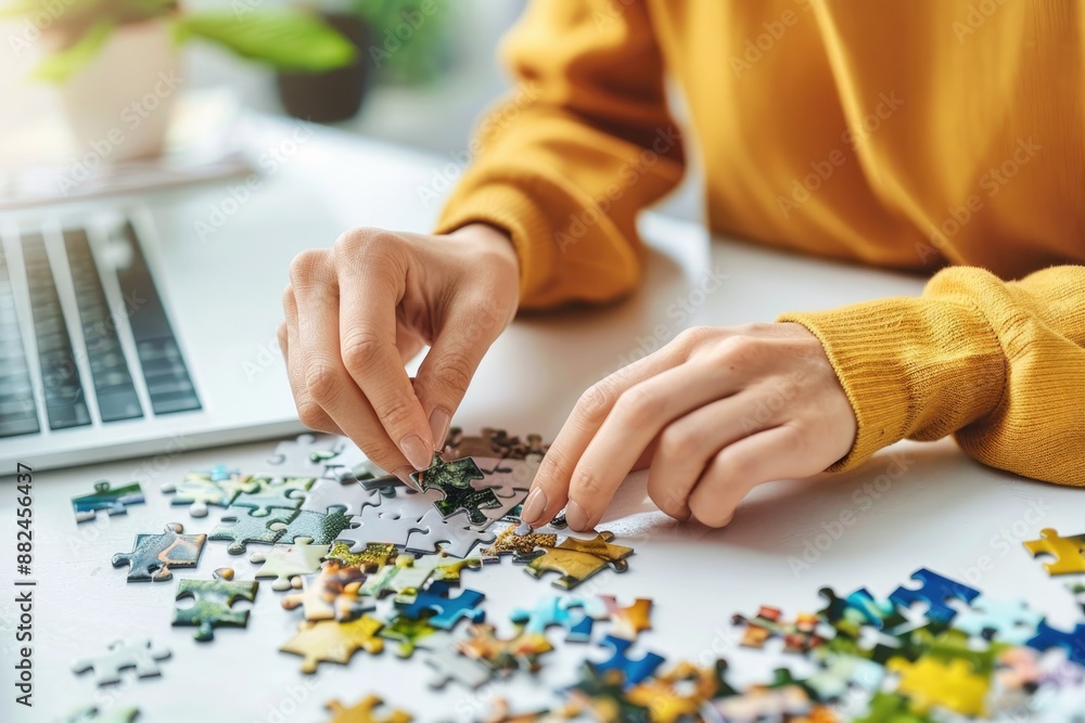 Person Doing Puzzle on Clean White Table Person Doing Puzzle on Clean White Table