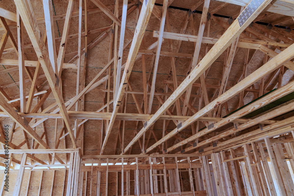 House with wooden framework frame is being constructed with support beams during construction process House with wooden framework frame is being constructed with support beams during construction process