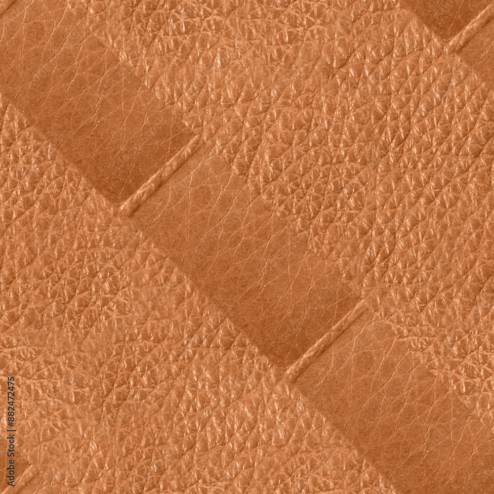 Fototapeta premium Seamless 4k photo texture photo of light brown colored leather material embossed with diagonal line pattern.