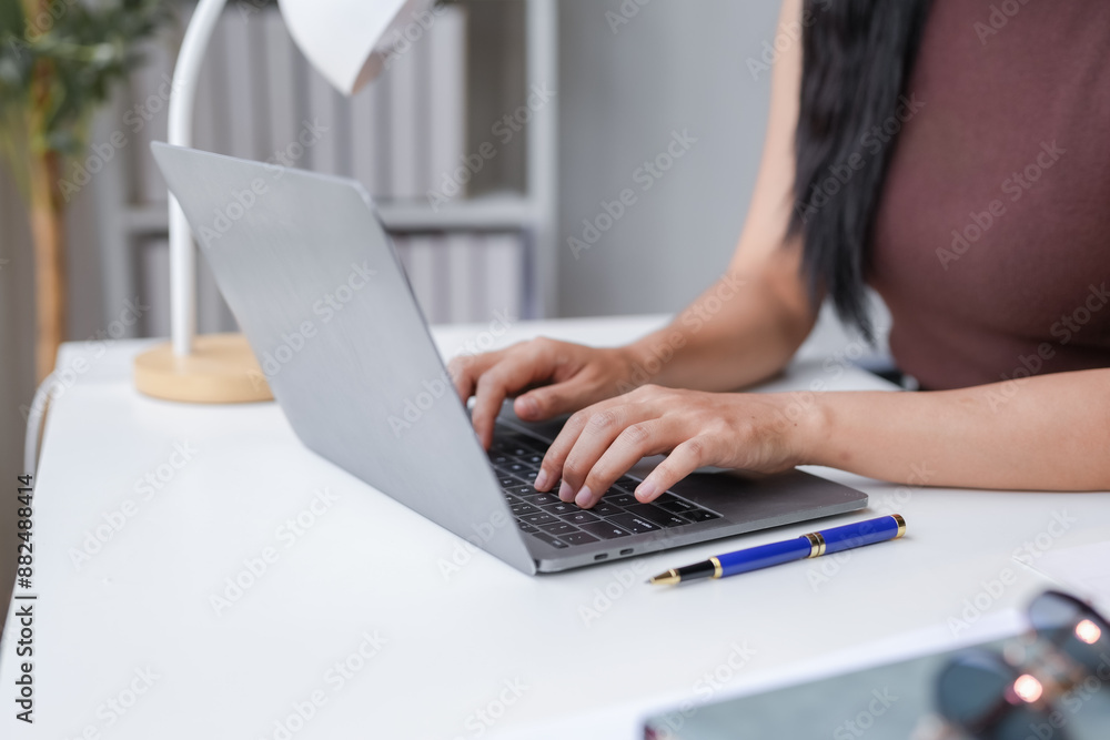 Focused businesswoman works from her cozy home office with a laptop, showcasing dedication and success Focused businesswoman works from her cozy home office with a laptop, showcasing dedication and success