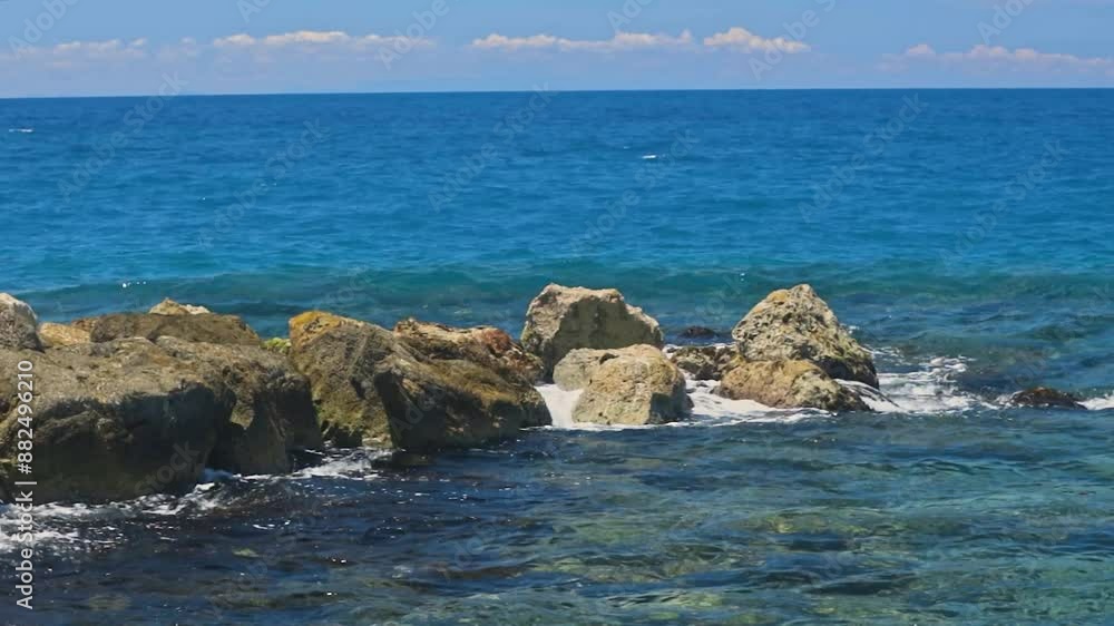 Beautiful view of slow-motion waves of Caribbean Sea crashing against rocks of shoreline. Curacao. Beautiful view of slow-motion waves of Caribbean Sea crashing against rocks of shoreline. Curacao.