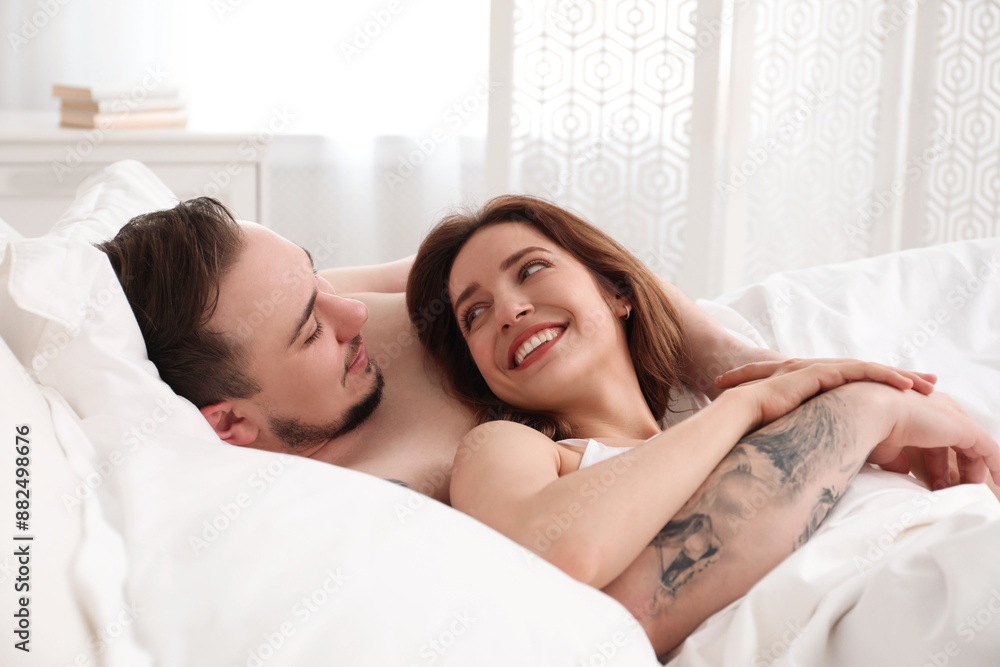 Lovely couple enjoying time together in bed at morning Lovely couple enjoying time together in bed at morning