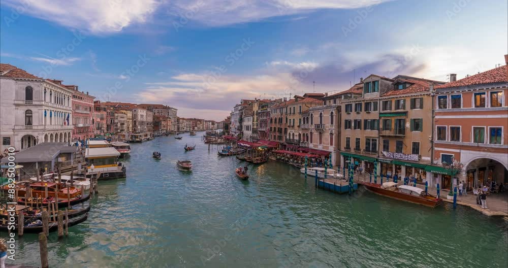 Venice, Italy - June 03, 2024: Cityscape view to canal from Ponte di Rialto bridge. boats traffic. Time-lapse. Medium cloudy sky. Venice, Italy - June 03, 2024: Cityscape view to canal from Ponte di Rialto bridge. boats traffic. Time-lapse. Medium cloudy sky.
