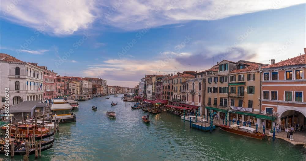 Venice, Italy - June 03, 2024: Cityscape view to canal from Ponte di Rialto bridge. boats traffic. Time-lapse, slide transition. Medium cloudy sky.