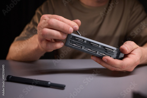 Person demonstrating precision with tools, repairing intricate electronics components