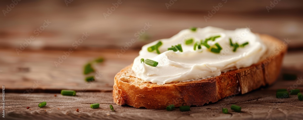 Close-up of a slice of bread with cream cheese and chives on a rustic wooden table, showcasing a tasty and simple snack. Close-up of a slice of bread with cream cheese and chives on a rustic wooden table, showcasing a tasty and simple snack.