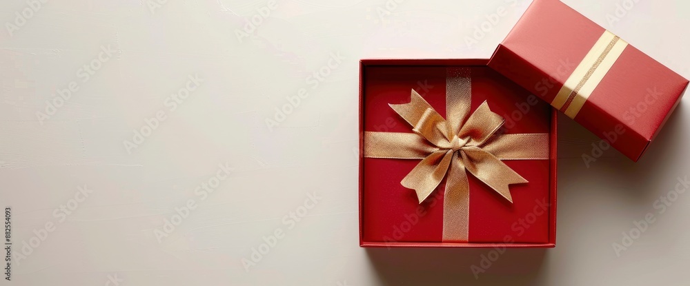 Open red gift box with gold ribbon and bow on a white background with shadow, classic and elegant Open red gift box with gold ribbon and bow on a white background with shadow, classic and elegant