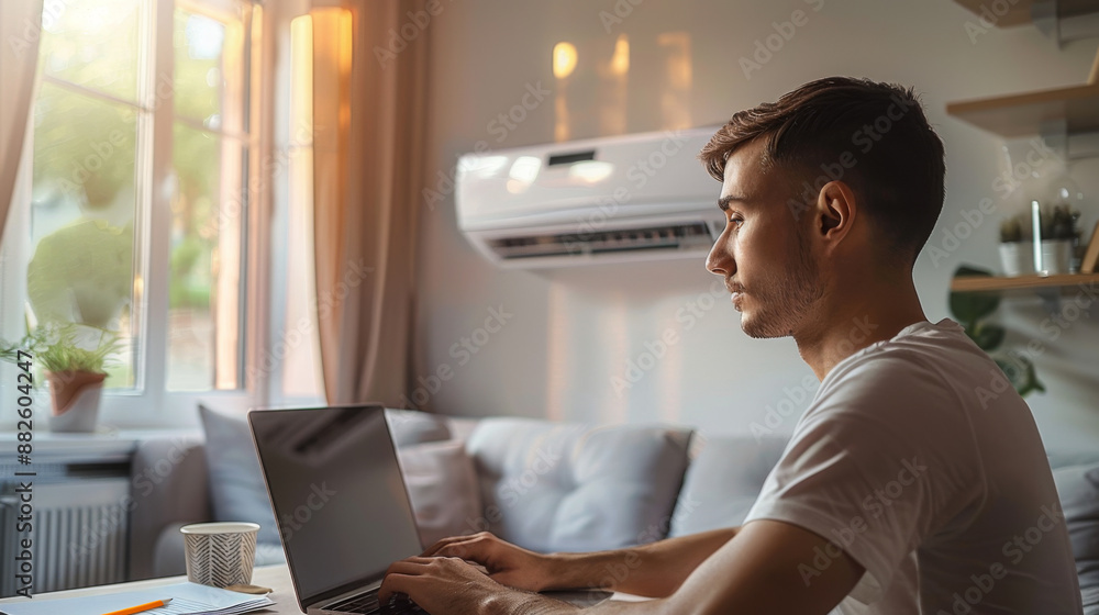 Young man working on laptop in sunlit home office, modern and minimalist workspace with natural light Young man working on laptop in sunlit home office, modern and minimalist workspace with natural light