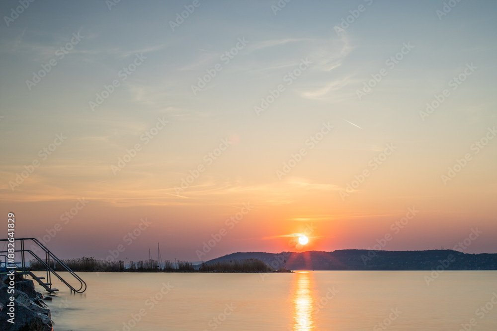 Landscape shot on the shore of a lake, nature in the sunset with a view to the horizon Siofok, Balaton, Hungary Landscape shot on the shore of a lake, nature in the sunset with a view to the horizon Siofok, Balaton, Hungary