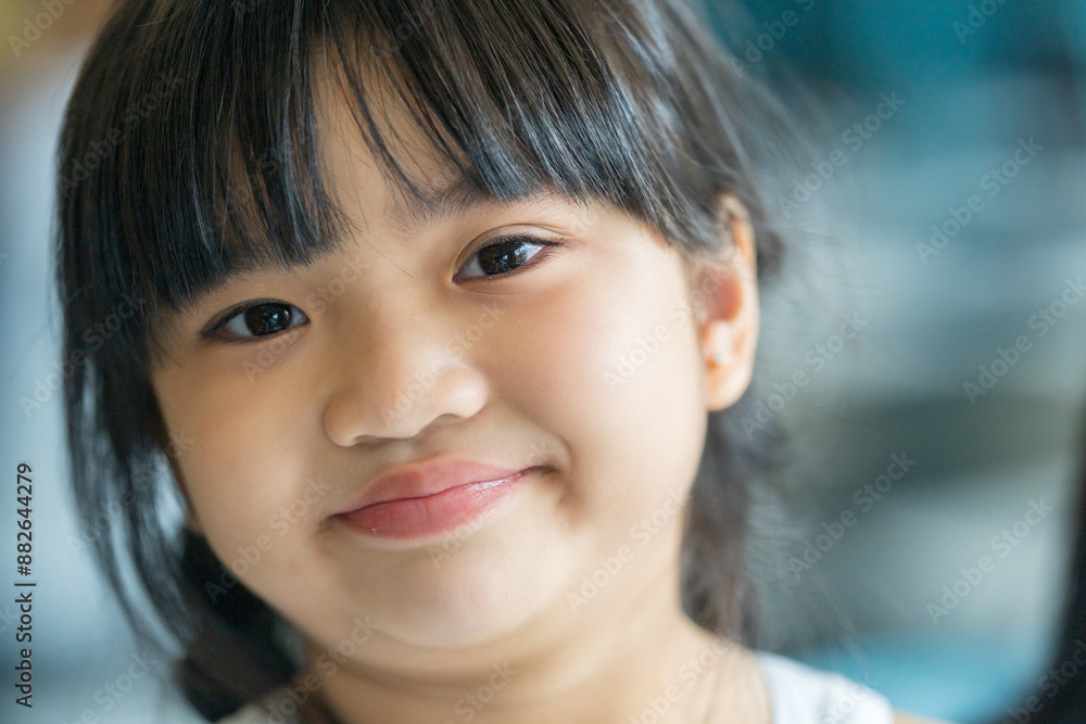 A six-year-old Malaysian girl enjoying an early summer afternoon at a stylish cafe in Selangor, Malaysia. A six-year-old Malaysian girl enjoying an early summer afternoon at a stylish cafe in Selangor, Malaysia.