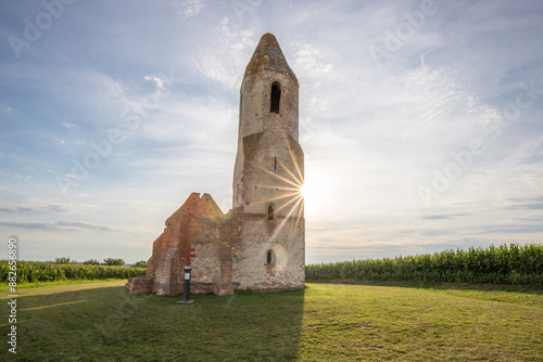 Old Catholic church, ruins in the middle of the corn field. Landscape shot at sunset Pusztatorony Hager, Somogyvámos Balaton, Hungary photo