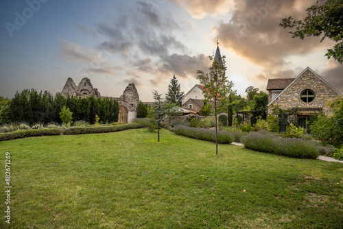 Old Catholic church, in front of it a lavender field. Landscape shot at sunset Levendárium Dörgicsei Levendula Major, Balaton, Hungary photo