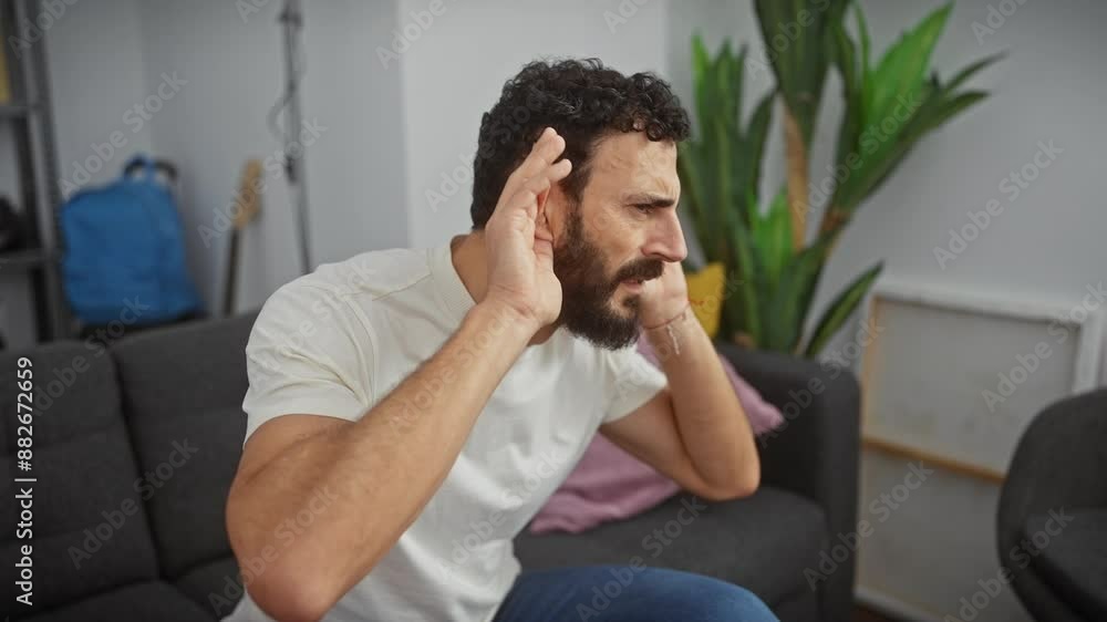 Curious middle-aged man with hearing problem, trying to hear juicy gossip indoors! handsome fellow in a white tee with hands to ears. Curious middle-aged man with hearing problem, trying to hear juicy gossip indoors! handsome fellow in a white tee with hands to ears.