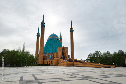 Mashkhur Jusup Mosque in the center of Pavlodar on a blue sky background in summer. photo