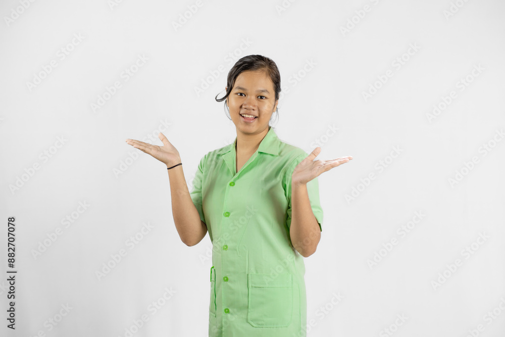 Young Asian female nurse raises her hands, gestures of ignorance, concept of health care and dedicated work, isolated white background.
Young Asian female nurse raises her hands, gestures of ignorance, concept of health care and dedicated work, isolated white background.