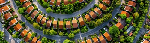 aerial view of suburbia - houses and green spaces in a curving street pattern.